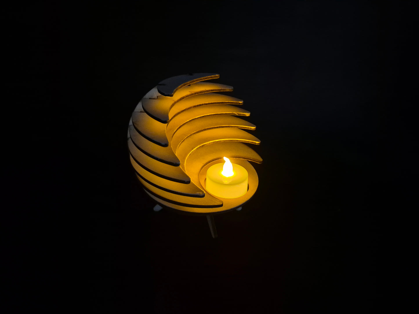 Spherical geometric tea light holder with intricate laser cut design and shadow effects
