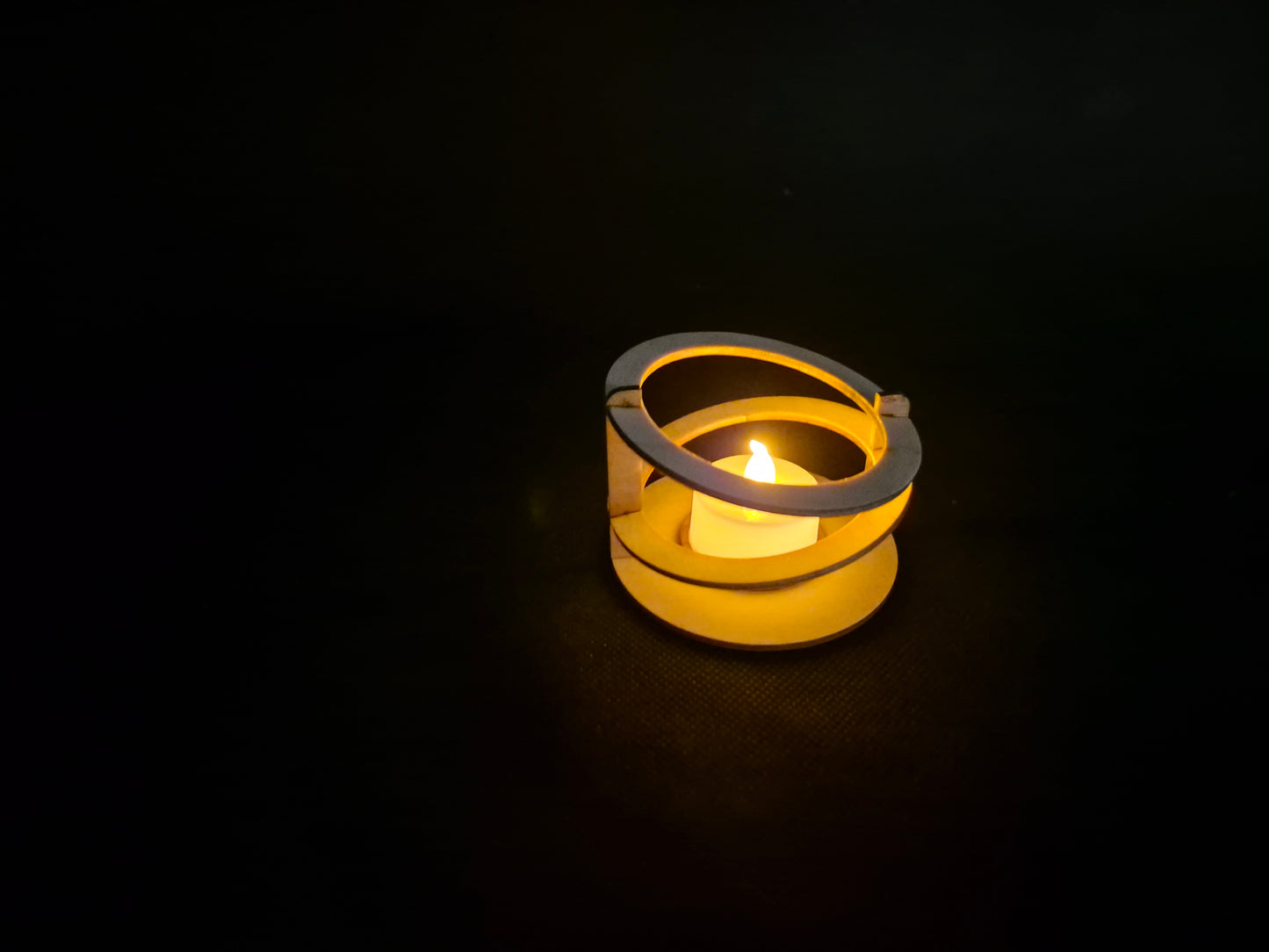 Modern ringed geometric tea light holder with intricate laser cut pattern and ambient lighting