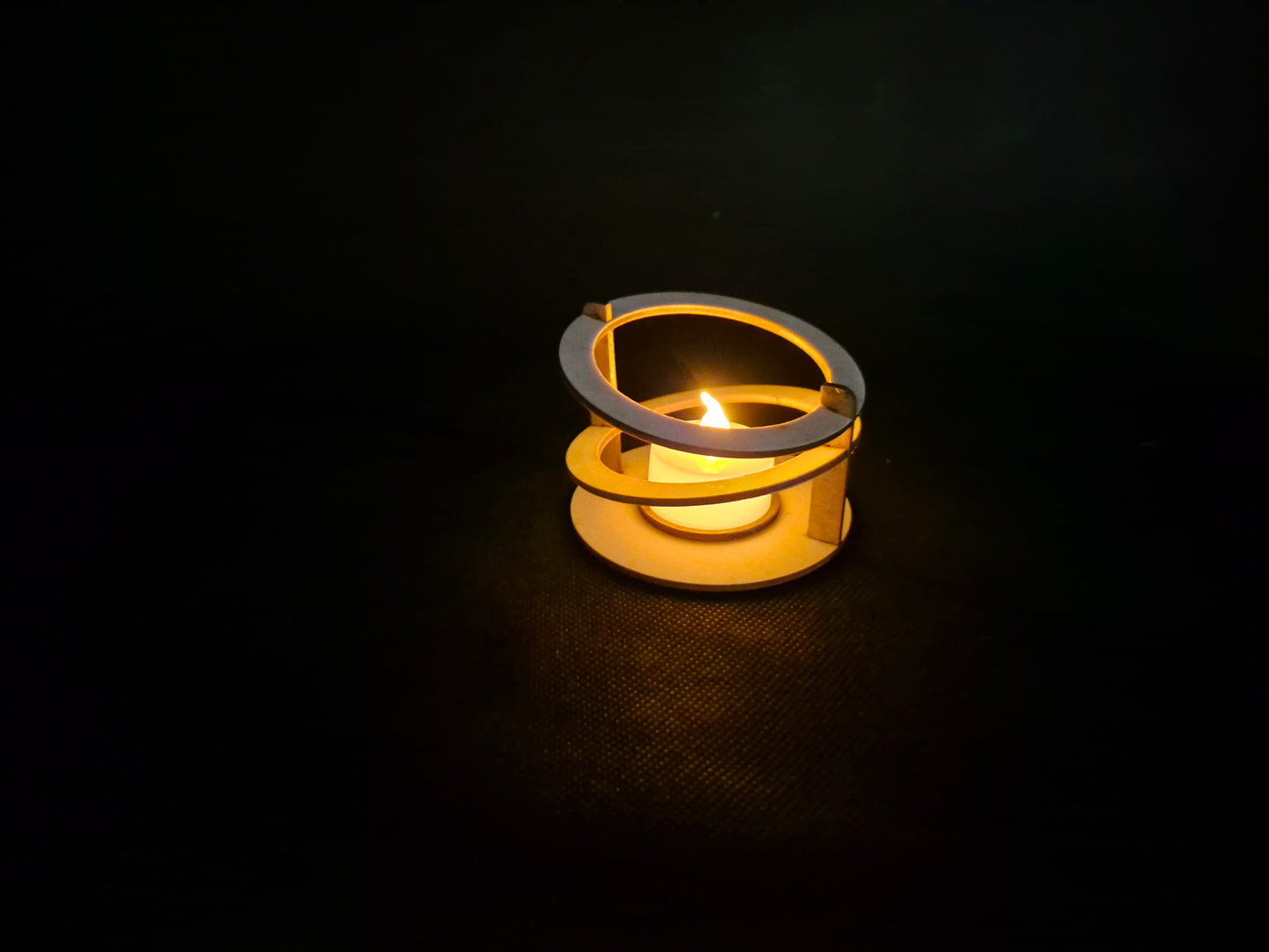 Modern ringed geometric tea light holder with intricate laser cut pattern and ambient lighting