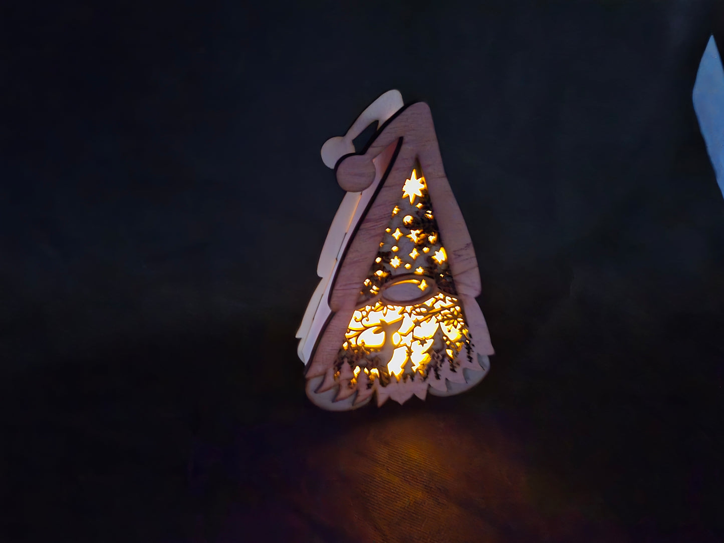 Illuminated wooden Gonk lamp with layered laser cut design and warm LED lighting