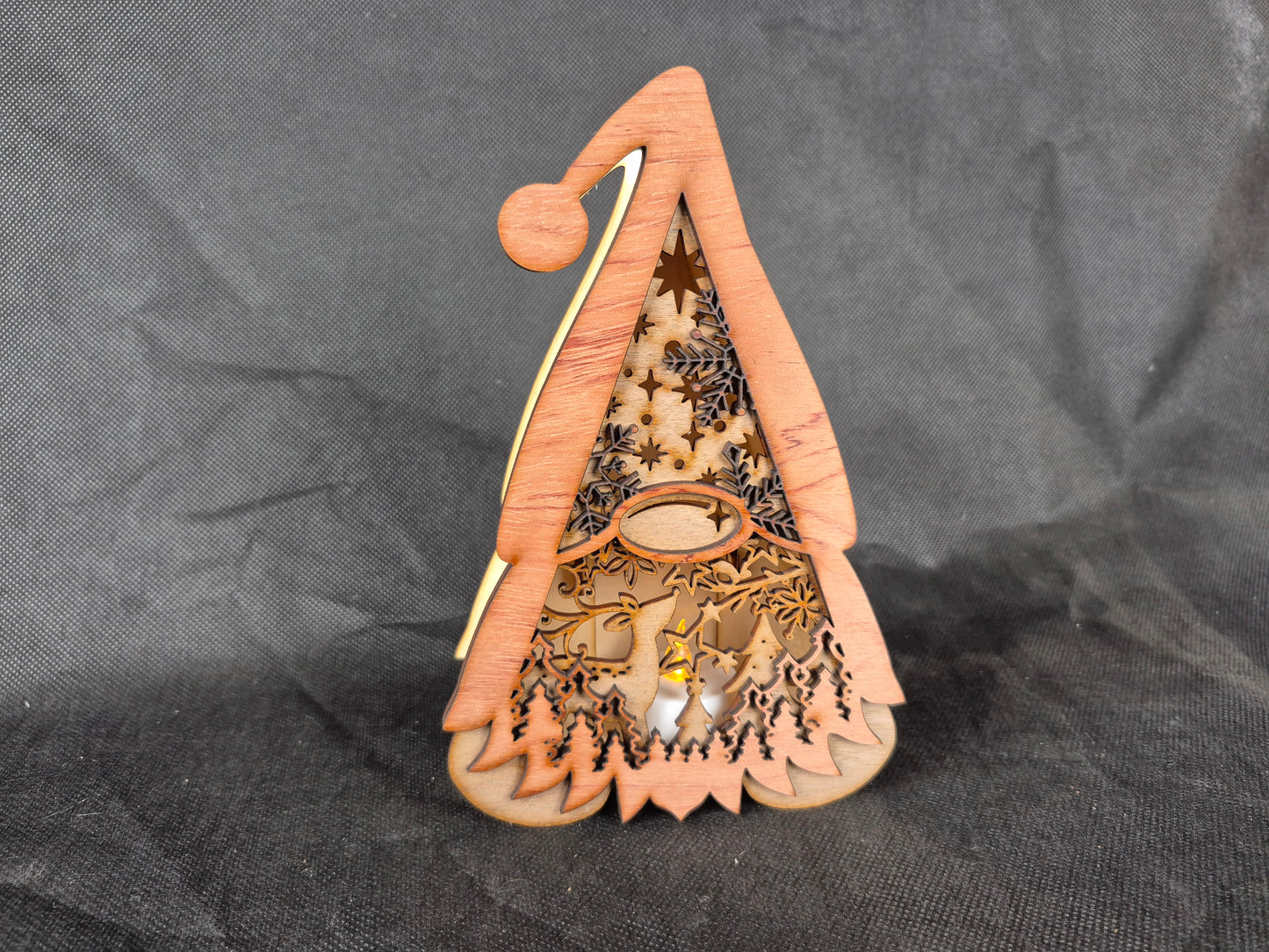 Illuminated wooden Gonk lamp with layered laser cut design and warm LED lighting