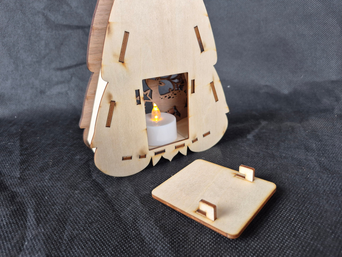 Illuminated wooden Gonk lamp with layered laser cut design and warm LED lighting