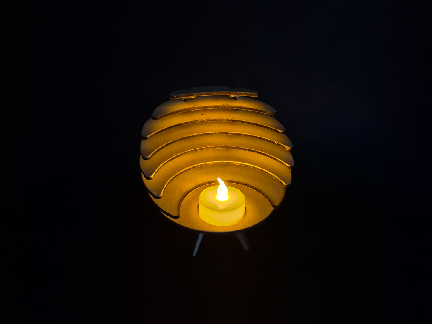 Spherical geometric tea light holder with intricate laser cut design and shadow effects