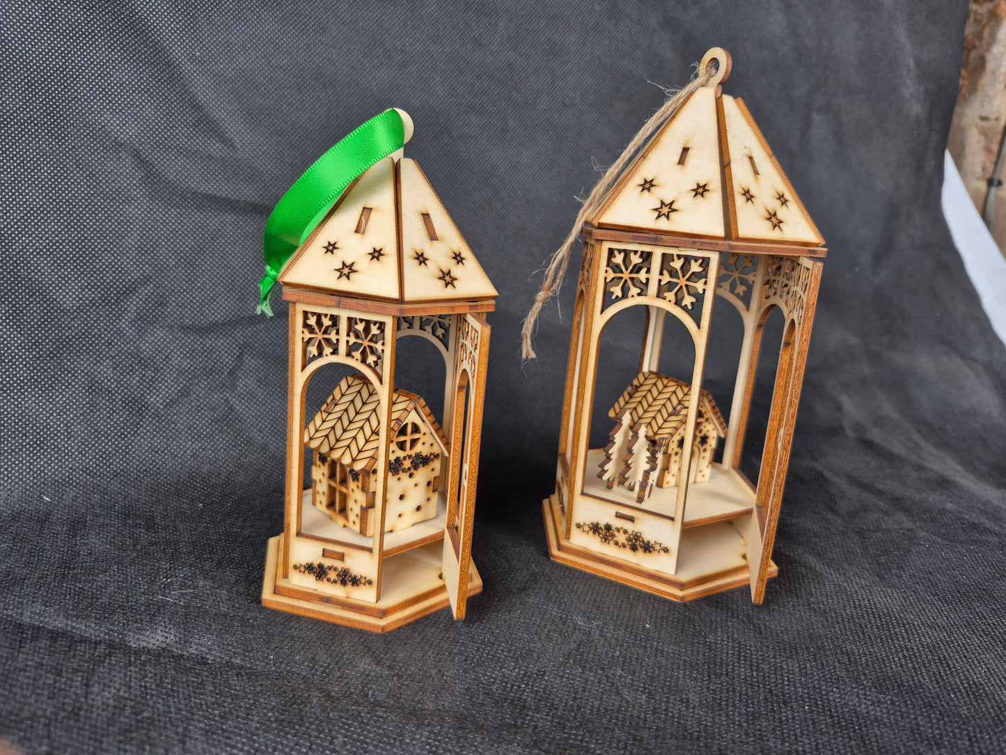 Laser cut wooden Christmas scene bauble with intricate holiday design and ribbon hanger